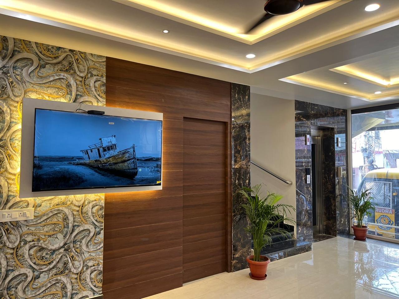 Lift lobby with textured stone wall and wood panelling
