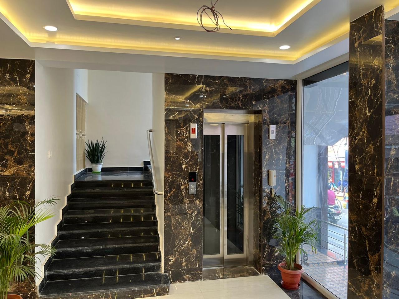Lift entrance in black-gold marble