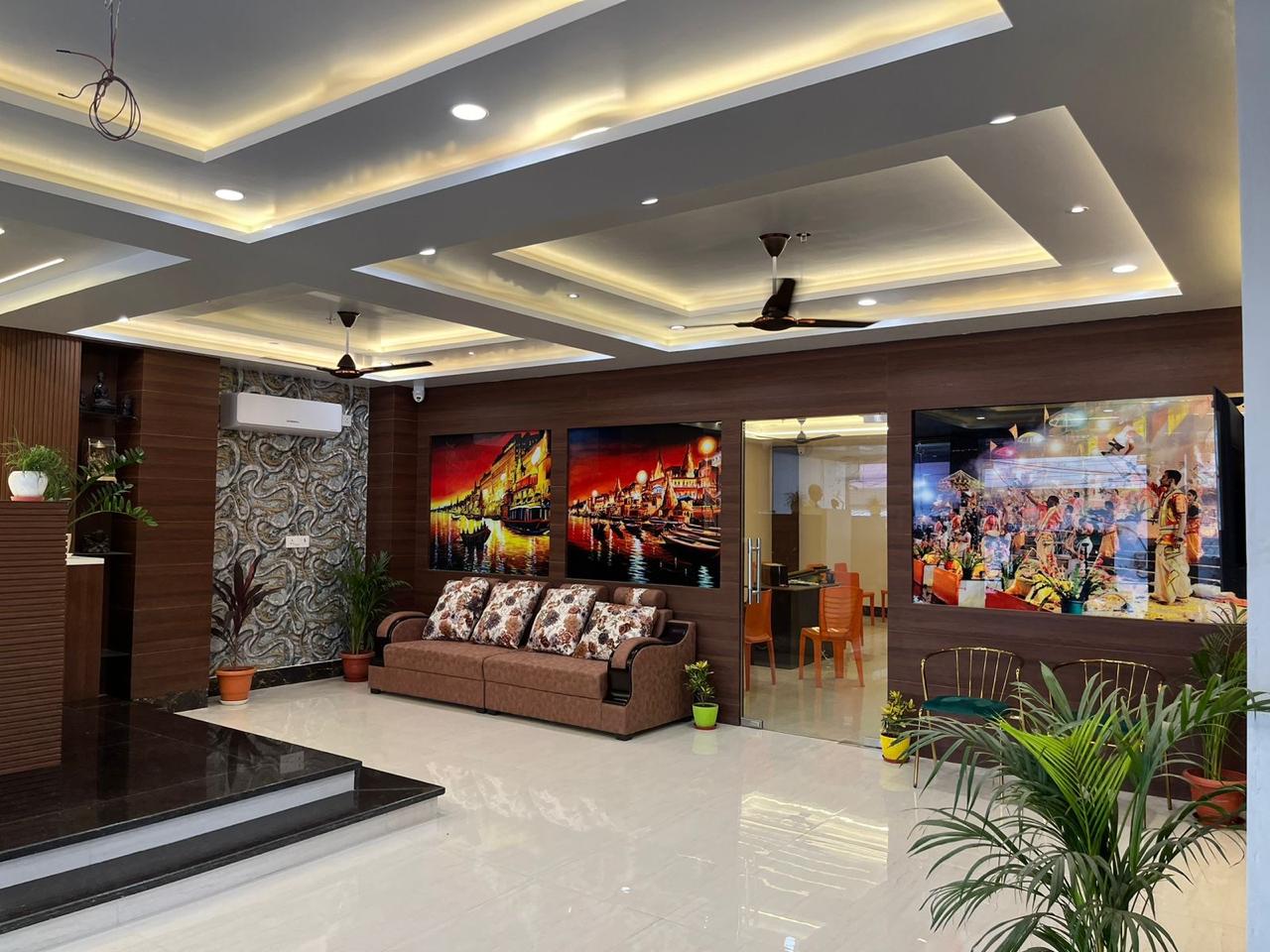 The lounge at Hotel Nandini Grand with paintings of the Varanasi ghats