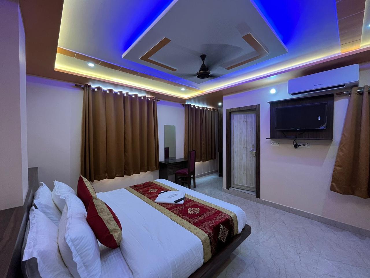 Deluxe Room at Hotel Nandini Grand with king bed and ambient ceiling lighting