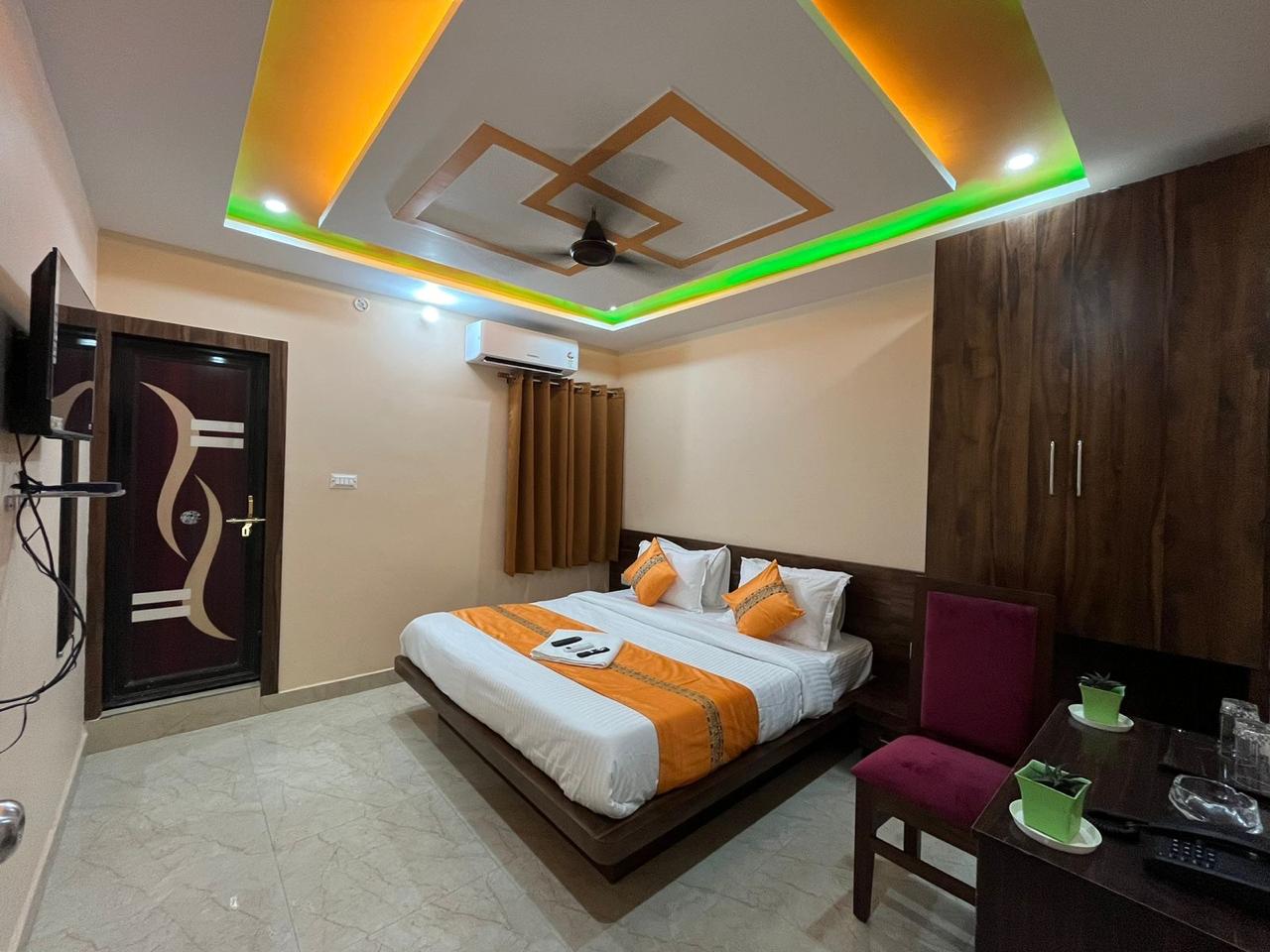 Executive Room at Hotel Nandini Grand with king bed, wardrobe and desk